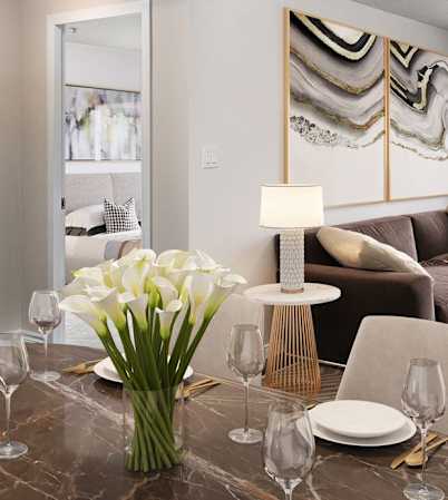 Open concept living and dining room staged with furniture.