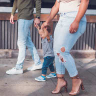 a woman holding a small child on a sidewalk at Sinclaire on Seminary, Alexandria
