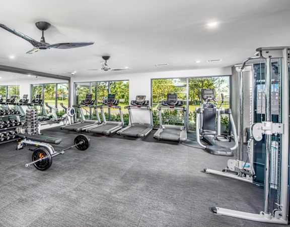 A spacious gym with a variety of equipment including treadmills, weights, and exercise machines.