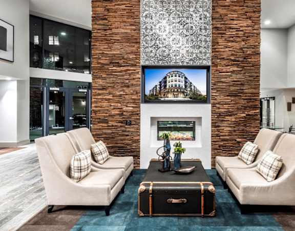 A living room with two couches, a fireplace, and a television.