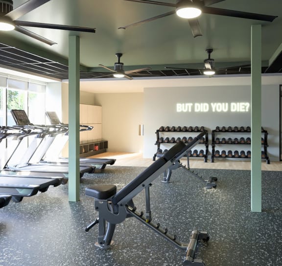 a gym with a row of exercise benches and a sign that says do you diet at Boardwalk at Research Park, Alabama, 35811