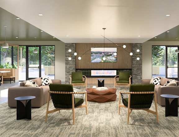 a living room with couches and chairs and a fireplace at Boardwalk at Research Park, Alabama, 35811