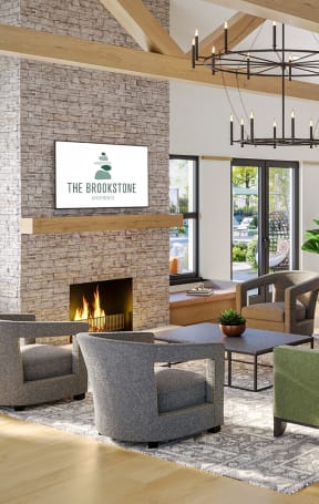 a living room with couches and chairs and a fireplace