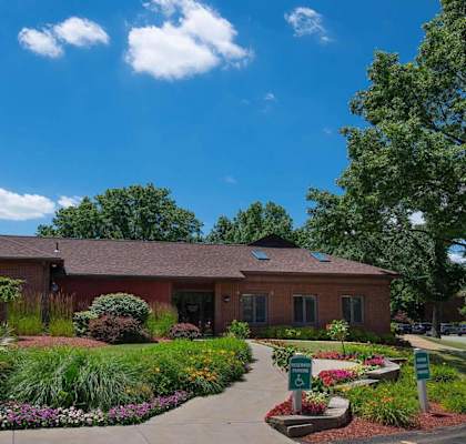 the front of the building with a landscaped garden in front of it at Deauville Park Apartments, Monroeville, PA