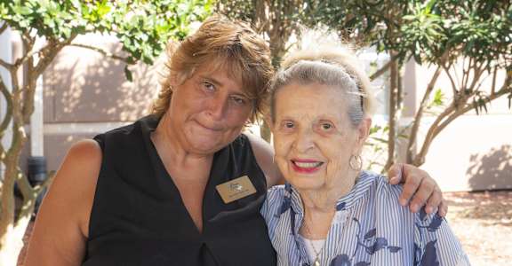 a woman with her arm around another woman