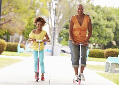 Mother and Daughter riding scooters | Gateway by Vintage Apartments in Spanaway, WA