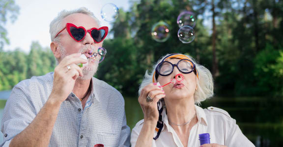 Seniors blowing bubbles l Napa, CA Senior Apartments 94558 l Vintage at Napa Senior Rentala