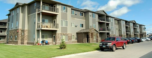 a red truck parked in front of an apartment building at Urban View Apartments, Fargo, ND