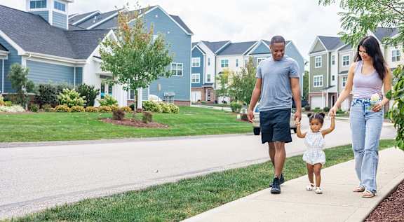 family of three standing in the middle of the road at Highland Village, Pennsylvania
