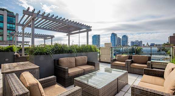 A patio with a fire pit and seating area.