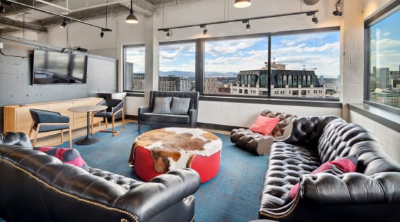 a living room with couches and a table with a large window