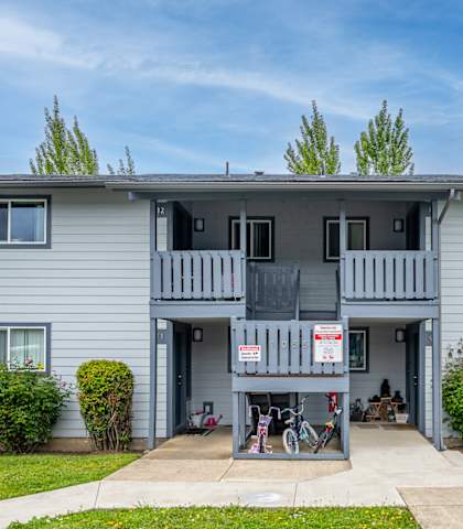 A two-story house with a balcony on the second floor.