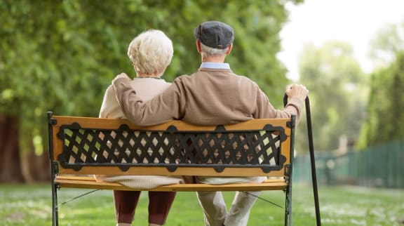 Couple Sitting on Park Bench Together