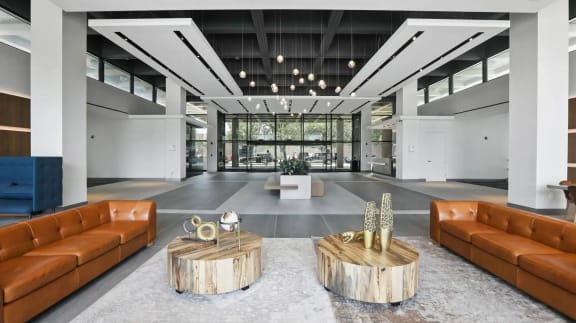 the lobby of a building with leather couches