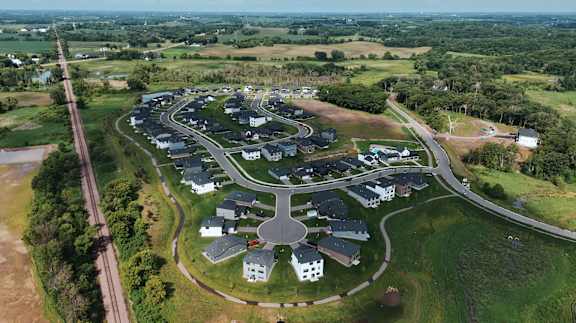 A bird's eye view of a residential area with houses and roads.