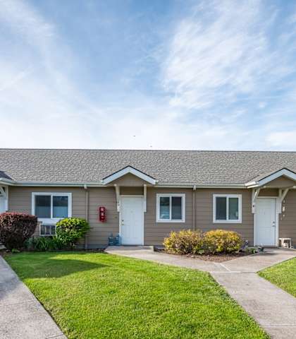a home with a sidewalk and lawn in front of it