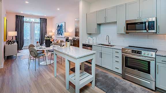 A kitchen with a table and chairs in the middle of the room.