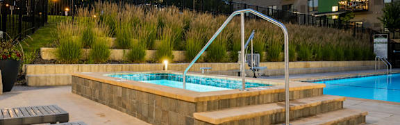 A small pool with a diving board and steps.