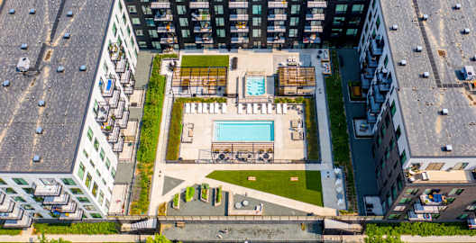 an aerial view of a building with a pool in the middle of it