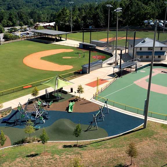 A park with a baseball field and a basketball court.