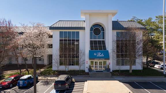 A large white building with a blue sign that says "The Hub".