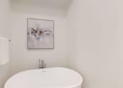 Thumbnail 37 of 51 - A white toilet with a white towel hanging on the wall.