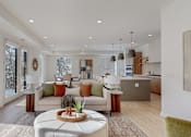 Thumbnail 1 of 51 - A modern living room with a large window and a view of trees outside.