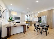 Thumbnail 49 of 51 - A modern kitchen with a dining table and chairs.