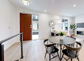 Thumbnail 45 of 51 - A modern dining room with a round table and chairs.