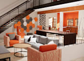Thumbnail 8 of 13 - A living room with orange and grey furniture.