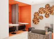 Thumbnail 7 of 13 - A room with orange walls and a white table with a laptop on it.