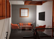 Thumbnail 5 of 13 - A living room with a grey floor and orange chairs.