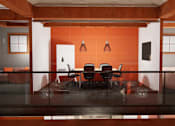 Thumbnail 3 of 13 - A conference room with a glass table and chairs.