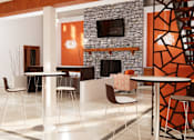 Thumbnail 1 of 13 - A modern dining area with a stone fireplace and a TV above it.
