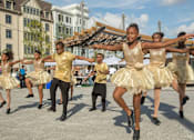 Thumbnail 2 of 6 - A group of dancers in gold dresses are performing on a stage.