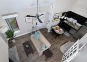 Thumbnail 1 of 60 - View of Fusion Orlando furnished apartment living space from loft. Open concept living room and kitchen with ceiling fan and in unit laundry. Apartments in Orlando.