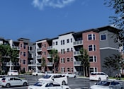 Thumbnail 8 of 8 - an architectural rendering of an apartment building with cars in a parking lot