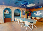 Thumbnail 3 of 8 - a conference room with a table and chairs and a television