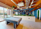 Thumbnail 5 of 8 - a game room with a pool table