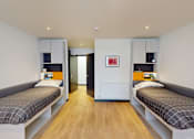 Thumbnail 1 of 16 - a bedroom with two beds and a closet