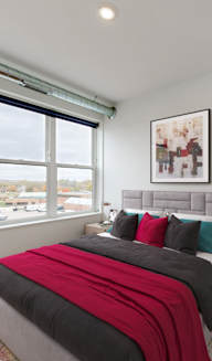 a bedroom with a bed and a large window