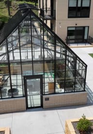 an aerial view of a greenhouse on the side of a building