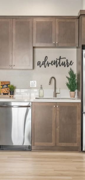 a kitchen with stainless steel appliances and a refrigerator