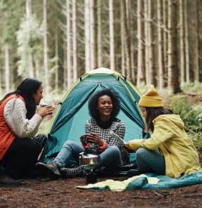 Friends Smiling while Camping Together