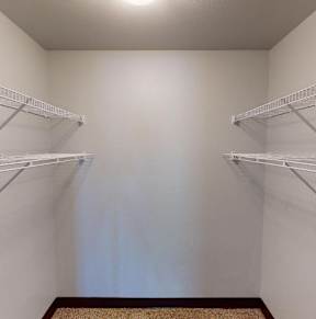 Three identical front loading washing machines are lined up in a laundromat.