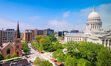A cityscape with a prominent white dome building in the center.