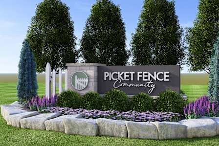 A sign that says Pickett Fence Community in front of trees.