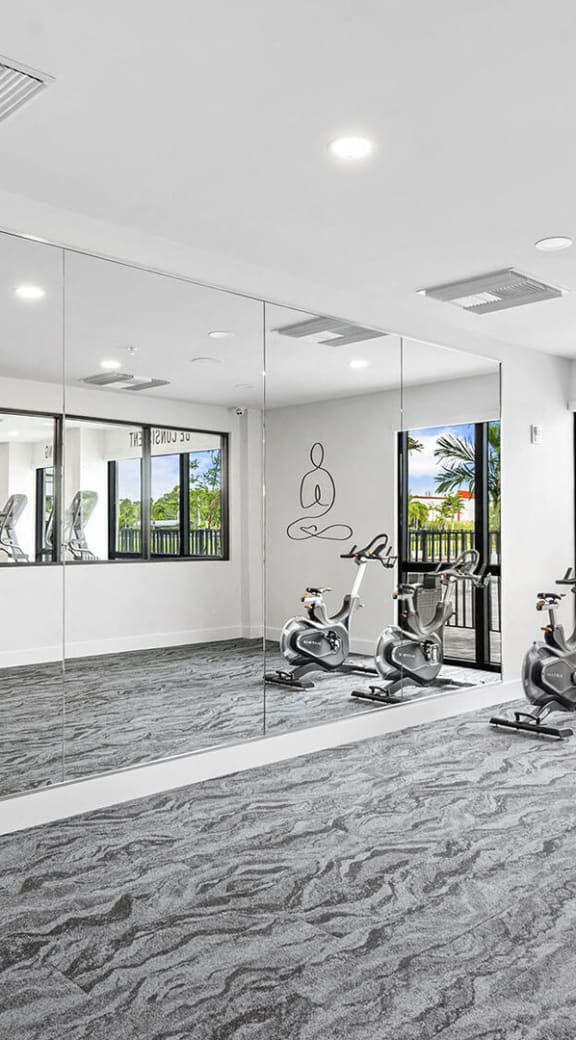 the gym has a yoga room and views of the city