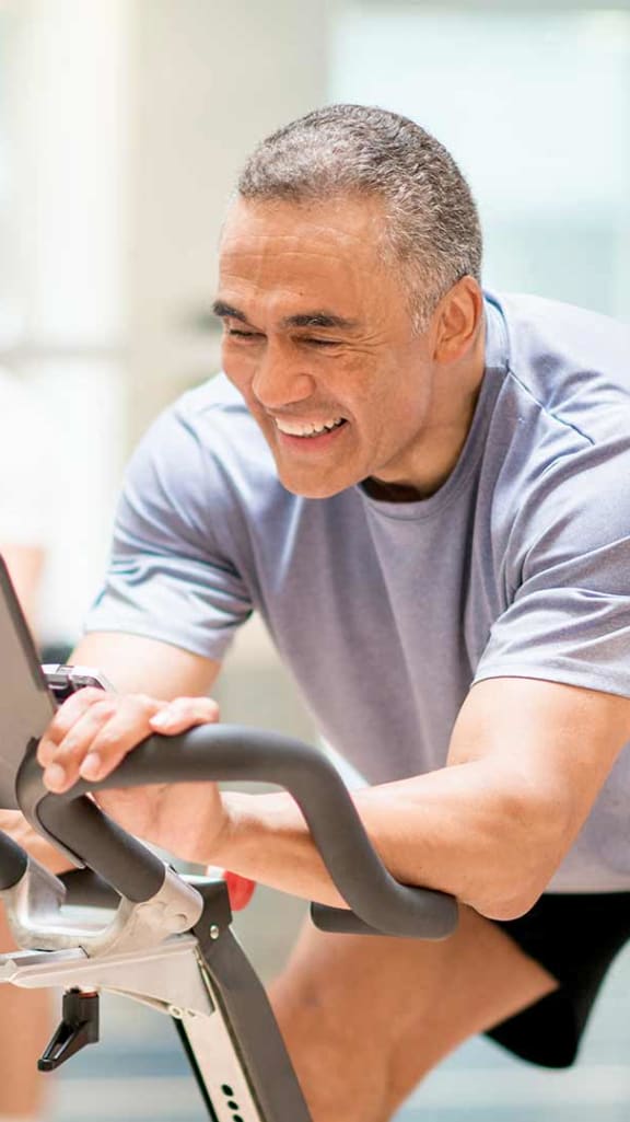 a group of people biking on an exercise bike in a gym