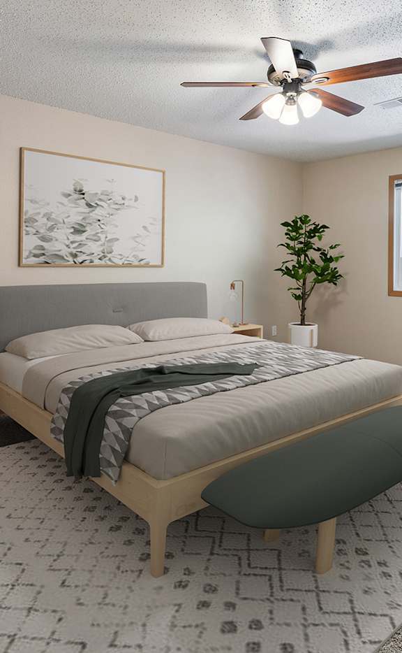 a bedroom with a bed and a ceiling fan